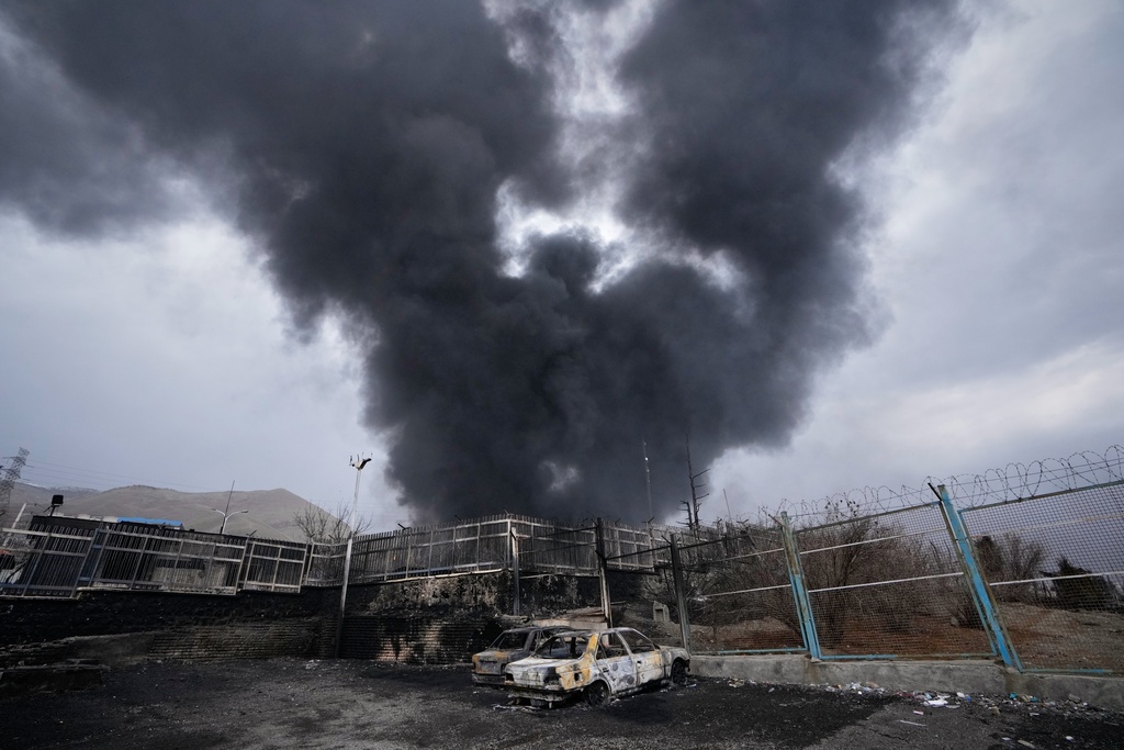 FILE - A thick plume of smoke rises from an oil storage facility hit by a U.S.-Israeli strike in Tehran, Iran, March 8, 2026. (AP Photo/Vahid Salemi, File)