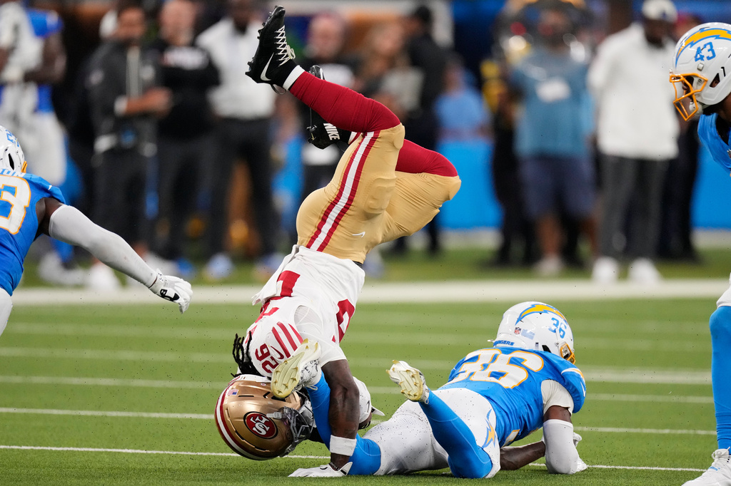 San Francisco 49ers running back Kaelon Black, left, is tackled by Los Angeles Chargers defensive back Avery Smith during the first half of a preseason NFL football game, Thursday, Aug. 20, 2026, in Inglewood, Calif. (AP Photo/Mark J. Terrill)
