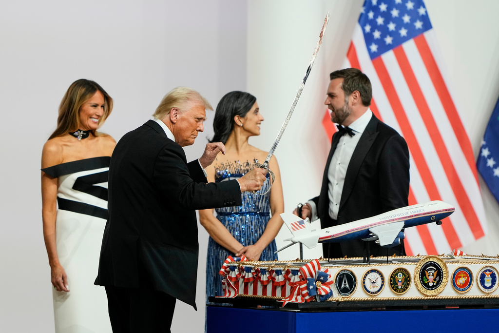 FILE - President Donald Trump holds a saber after using it to cut a cake at the Commander in Chief inaugural ball in Washington, Jan. 20, 2025. (AP Photo/Ben Curtis, File)