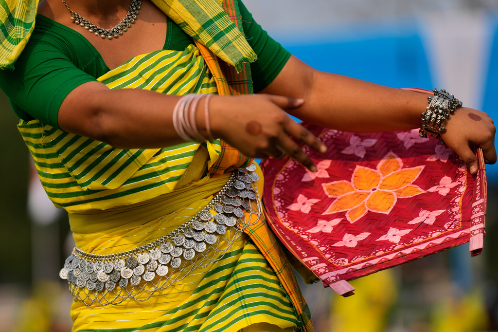 A Koch Rajbonshi girl in traditional attire performs a Guwaloni dance during the Rongali Bihu festival, organized by the All Assam Students Union in Guwahati, in the northeastern state of Assam, India, Tuesday, April 14, 2026. (AP Photo/Anupam Nath) CORRECTION: Corrects location detail; removes incorrect reference to Guwahati as the capital of Assam.