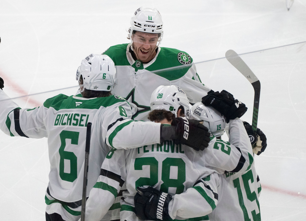Dallas Stars' Alexander Petrovic (28) celebrates after his goal over the Montreal Canadiens with teammates Lian Bichsel (6), Nathan Bastian (11) and Colin Blackwell (15) during third-period NHL hockey game action in Montreal, Thursday, Nov. 13, 2025. (Christinne Muschi/The Canadian Press via AP)