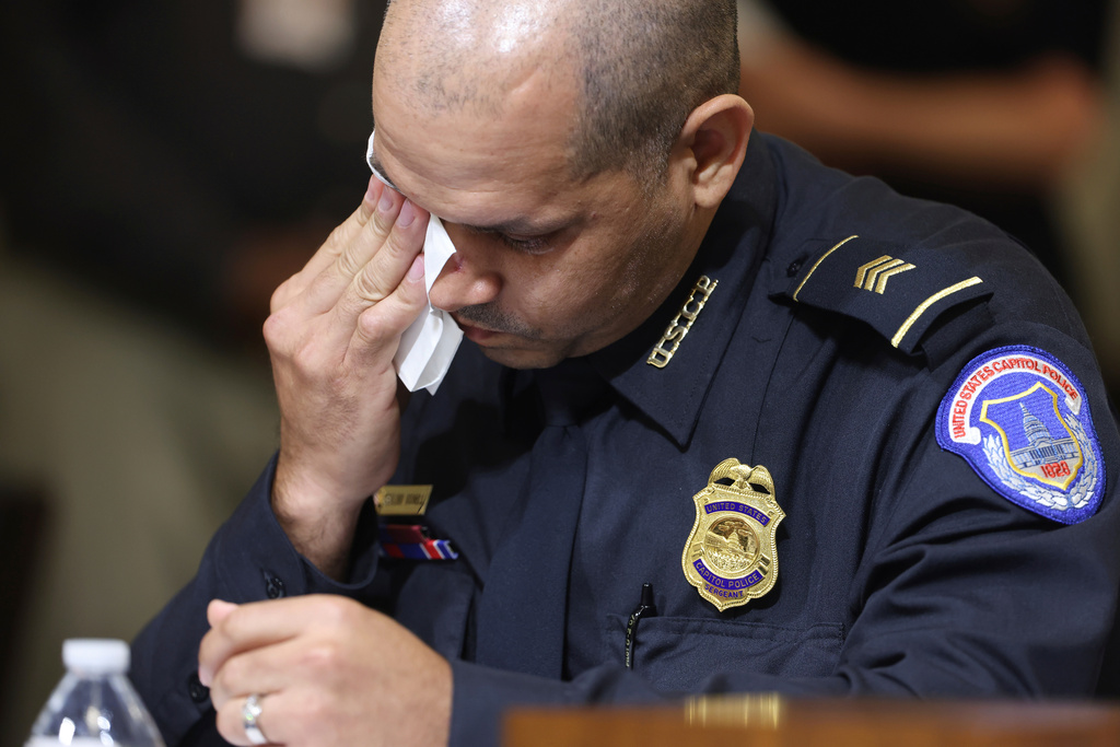 FILE - U.S. Capitol Police Sgt. Aquilino Gonell wipes his eye as he watches a video being displayed during a House select committee hearing on the Jan. 6 attack on Capitol Hill in Washington, July 27, 2021. (Jim Lo Scalzo/Pool via AP, File)