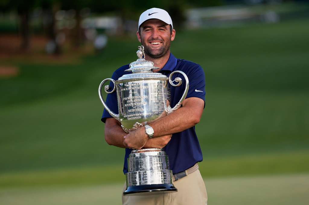 FILE - Scottie Scheffler holds the Wanamaker trophy after winning the PGA Championship golf tournament at the Quail Hollow Club, Sunday, May 18, 2025, in Charlotte, N.C. (AP Photo/David J. Phillip, File)