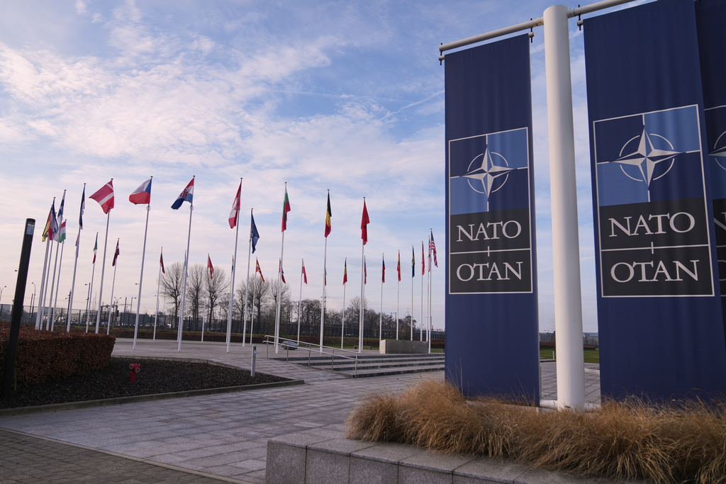 Flags flap in the wind outside NATO headquarters in Brussels, Monday, Jan. 19, 2026. (AP Photo/Virginia Mayo)