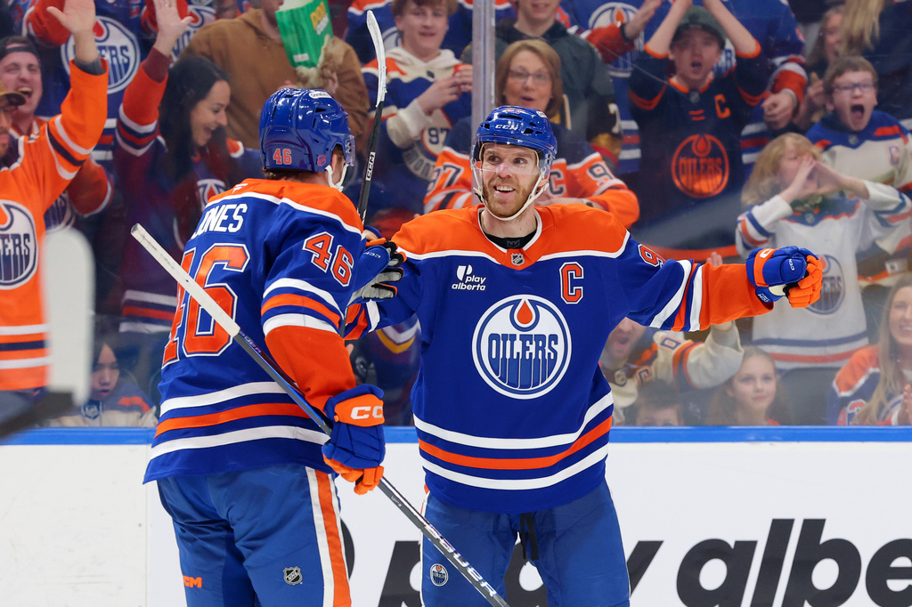 Edmonton Oilers' Connor McDavid (97) celebrates a goal with Max Jones (46) during the second period of an NHL hockey game against the Anaheim Ducks in Edmonton, Alberta, Saturday March 28, 2026. (James Maclennan/The Canadian Press via AP)