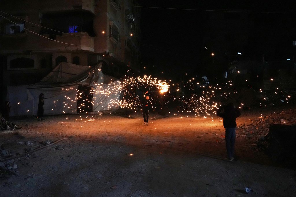 Palestinian children play with fireworks as they celebrate the Muslim holy month of Ramadan in Khan Younis, Gaza Strip, Wednesday, Feb. 18, 2026. (AP Photo/Abdel Kareem Hana)