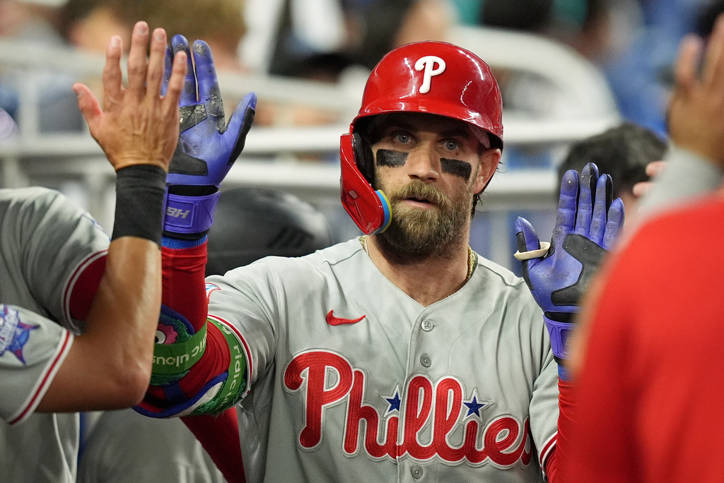 Philadelphia Phillies' Bryce Harper celebrates with teammates after hitting a home run during the third inning of a baseball game against the Miami Marlins, Monday, May 4, 2026, in Miami. (AP Photo/Rebecca Blackwell)