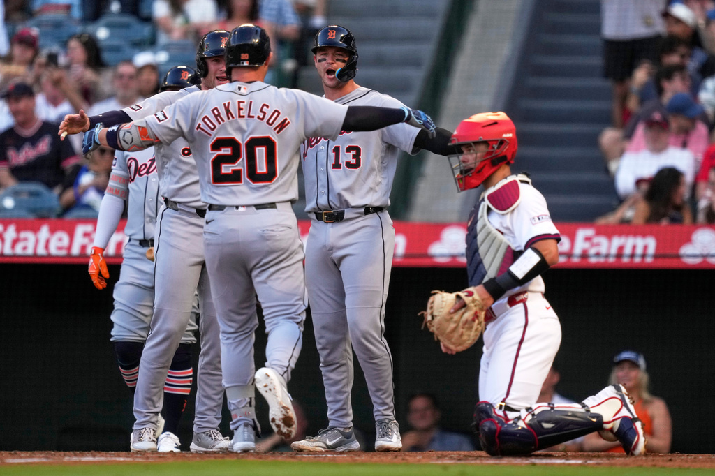 Detroit Tigers' Spencer Torkelson, center, is congratulated by Colt Keith, second from left, and Dillon Dingler, second from right, after hitting a three-run home run as Los Angeles Angels catcher Logan O'Hoppe, ring, watches during the first inning of a baseball game Saturday, July 18, 2026, in Anaheim, Calif. (AP Photo/Mark J. Terrill)