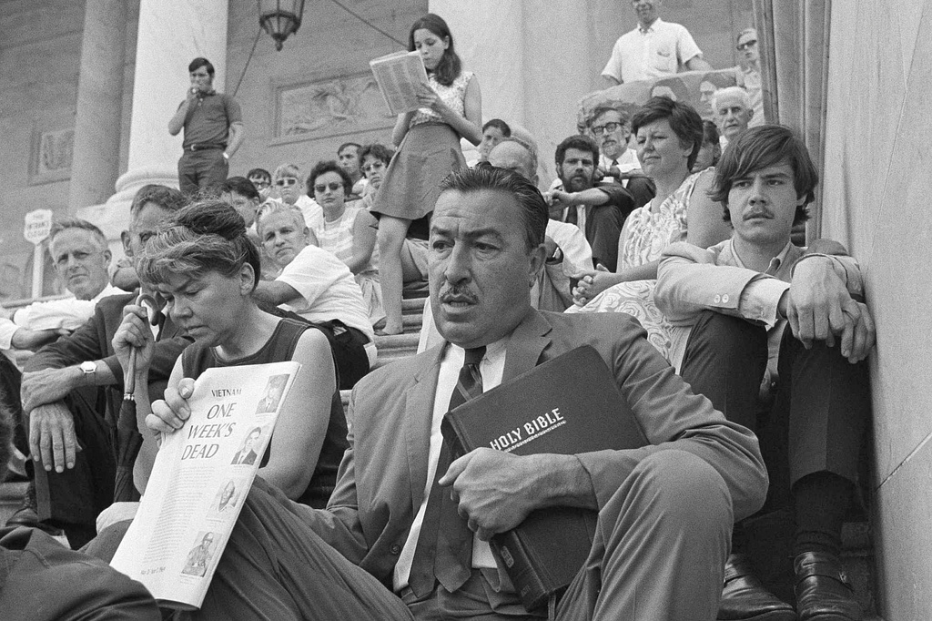 FILE - Rep. Adam Clayton Powell, D-N.Y., sits with Vietnam War protesters on the steps of the Capitol in Washington, on June 25, 1969. (AP Photo/Bob Daugherty, File)