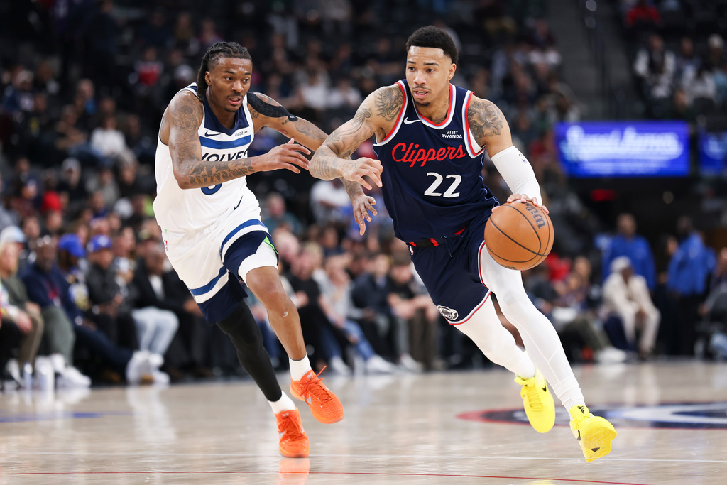 Los Angeles Clippers guard Jordan Miller (22) dribbles against Minnesota Timberwolves guard Bones Hyland, left, during the first half of an NBA basketball game, Wednesday, March 11, 2026, in Inglewood, Calif. (AP Photo/Jessie Alcheh)