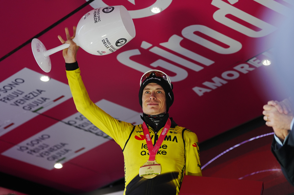 Denmark's Jonas Vingegaard celebrates on the podium after winning the 9th stage of the Giro d'Italia cycling race, from Cervia to Corrno alle Scale, Italy, Sunday May 17, 2026. (Massimo Paolone/LaPresse via AP)