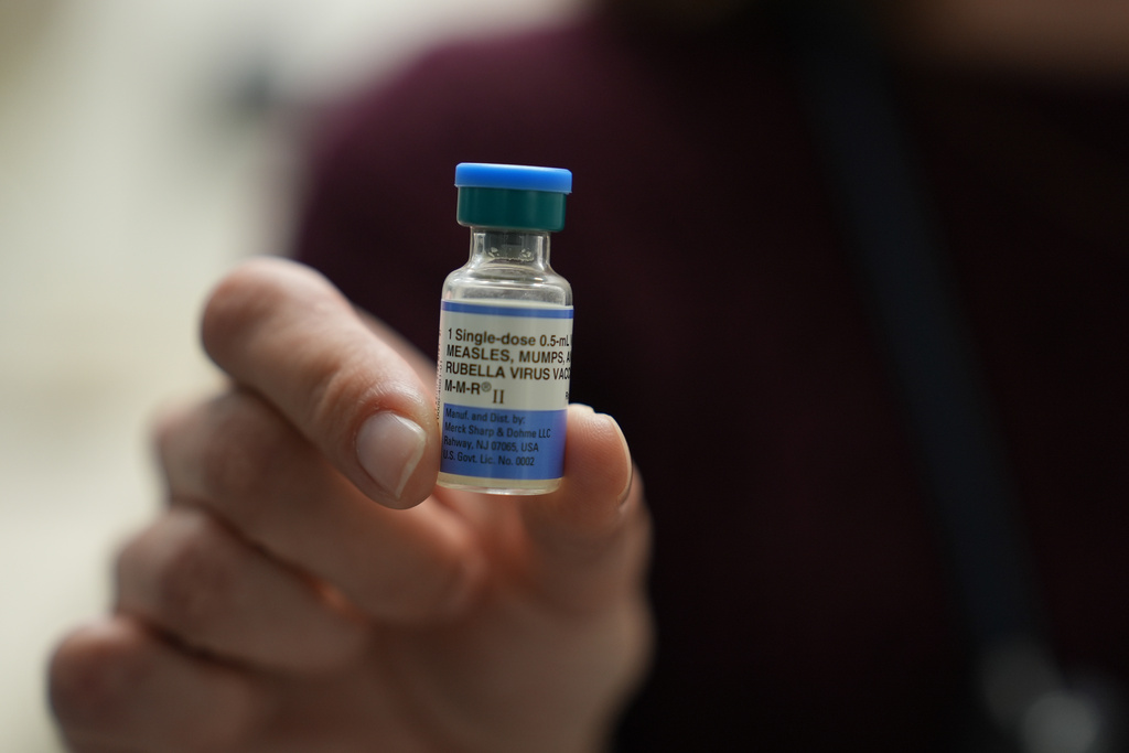 FILE - Dr. Jessica Early holds a vial of the combination measles, mumps and rubella vaccine at Prisma Health Pediatrics in Greer, S.C., March 18, 2026. (AP Photo/Mary Conlon, File)