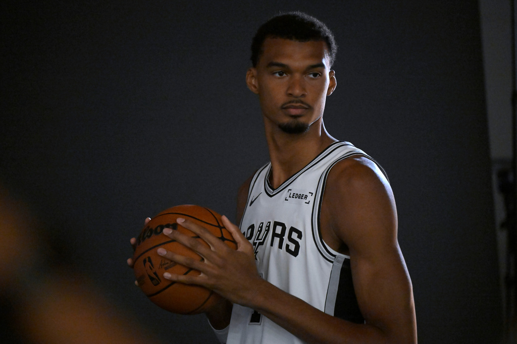 San Antonio Spurs center Victor Wembanyama poses for photos during the team's NBA basketball media day event, Monday, Sept. 28, 2026, in San Antonio. (AP Photo/Darren Abate)