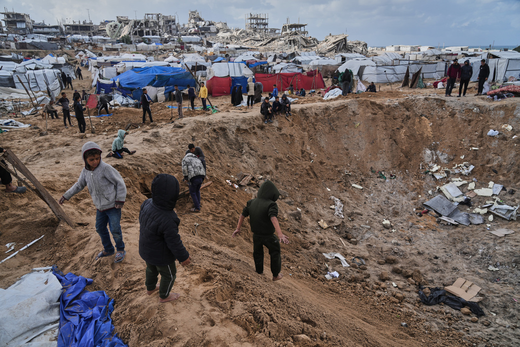 Palestinians inspect the damage at a displacement camp following an Israeli strike in Gaza City, Friday, Jan. 9, 2026. (AP Photo/Jehad Alshrafi)