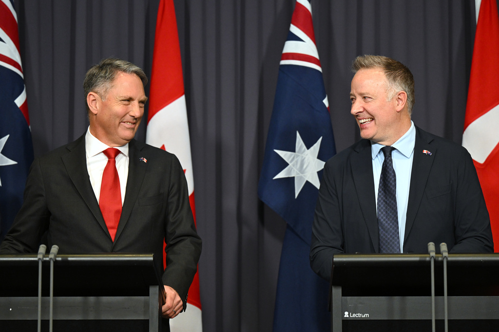 Australian Defense Minister Richard Marles, left, and Canada's Secretary of State Stephen Fuhr speak to the media after signing an agreement on export of an Over-the-Horizon Radar system at Parliament House in Canberra, Australia, Monday, June 22, 2026. (Lukas Coch/AAP Image via AP)