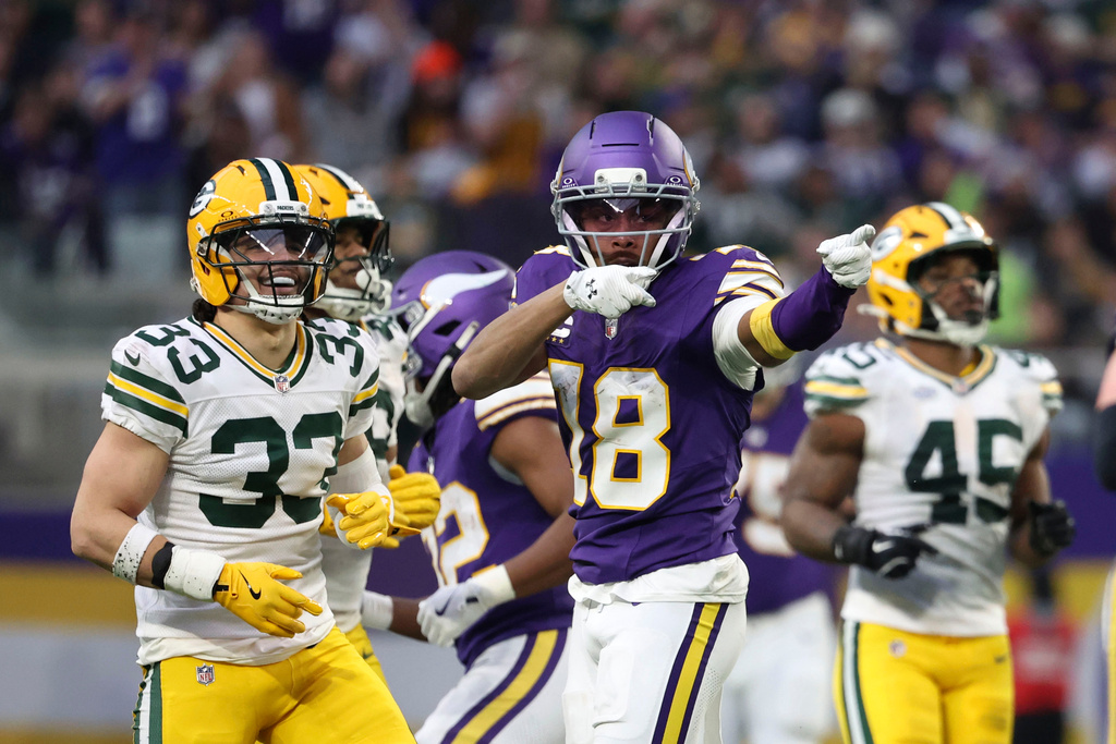 Minnesota Vikings wide receiver Justin Jefferson (18) celebrates in front of Green Bay Packers safety Evan Williams (33) after catching a pass during the first half of an NFL football game, Sunday, Jan. 4, 2026, in Minneapolis. (AP Photo/Ellen Schmidt)