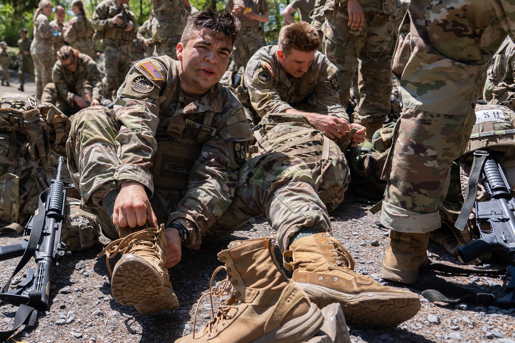 A University of Santa Barbara Army ROTC cadet laces up his boots after competing in the zodiac boat portion of the Sandhurst Military Skills Competition at the United States Military Academy in West Point, N.Y., Friday, May 1, 2026. (AP Photo/Julia Demaree Nikhinson)