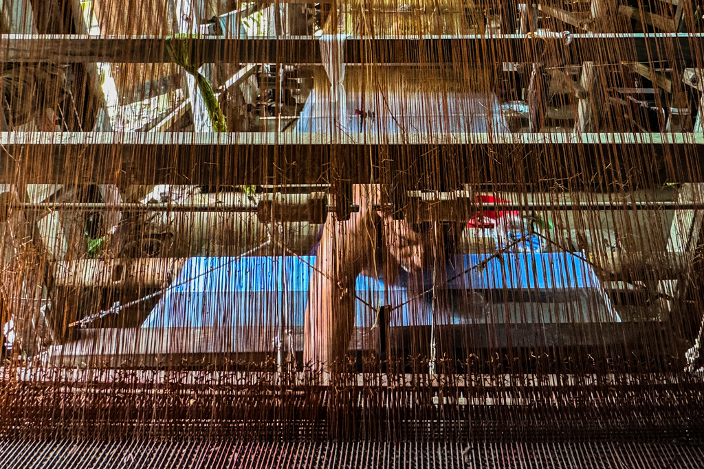 A weaver crafts a Tangail saree on a traditional hand-operated loom at a weaving workshop in Tangail District, Bangladesh, Nov. 5, 2025. (AP Photo/Mahmud Hossain Opu)