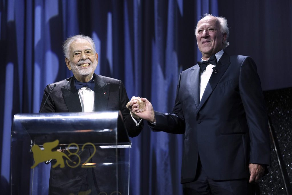 Francis Ford Coppola, left, presents the Golden Lion for lifetime achievement to Werner Herzog during the opening ceremony and the premiere of the film 'La Grazia' during the 82nd edition of the Venice Film Festival in Venice, Italy, on Wednesday, Aug. 27, 2025. (Photo by Scott A Garfitt/Invision/AP)