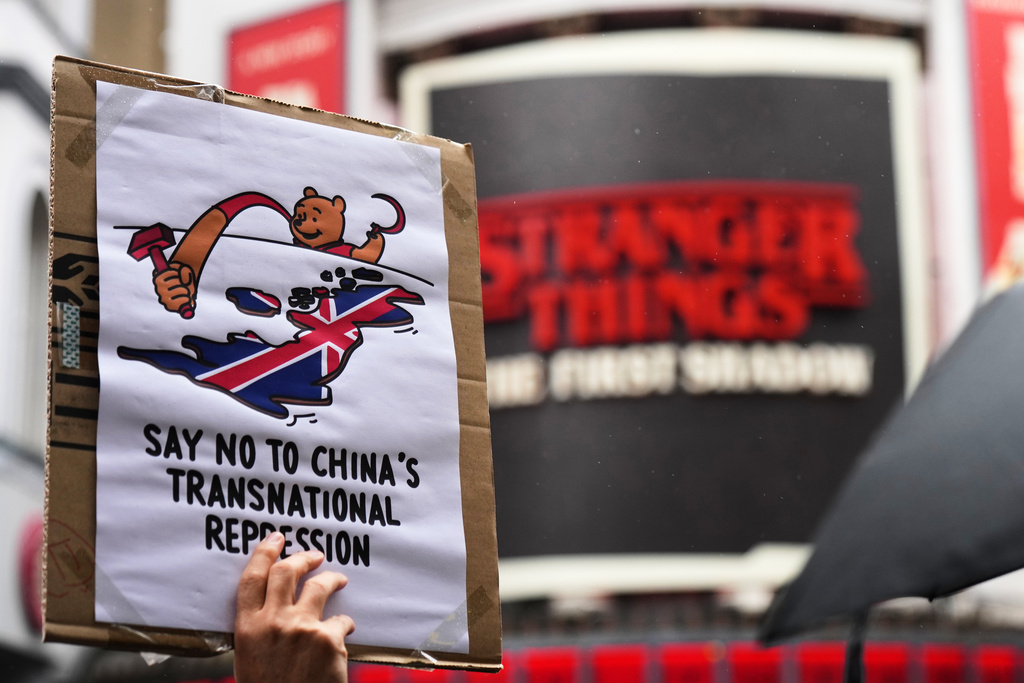 FILE - Protesters hold umbrellas, placards, and flags as they demonstrate against the proposed building of a new Chinese embassy, and to mark the 11th year of the Umbrella Revolution in Hong Kong, in London, Sunday, Sept. 28, 2025. (AP Photo/Joanna Chan, file)