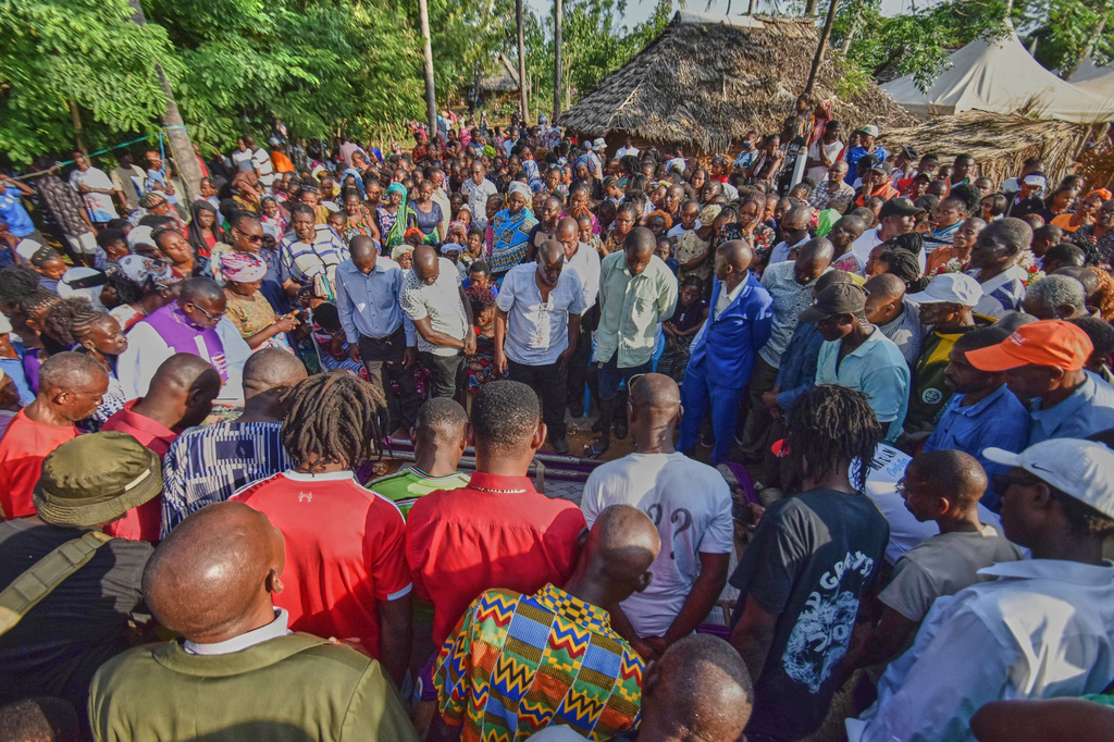 Mourners gather as the casket of 29 years old Penina Zawadi, who died from complications while giving birth, is lowered into her grave during her funeral in Kilifi County, Kenya, Saturday, July 18, 2026. (AP Photo/Brian Wachira)