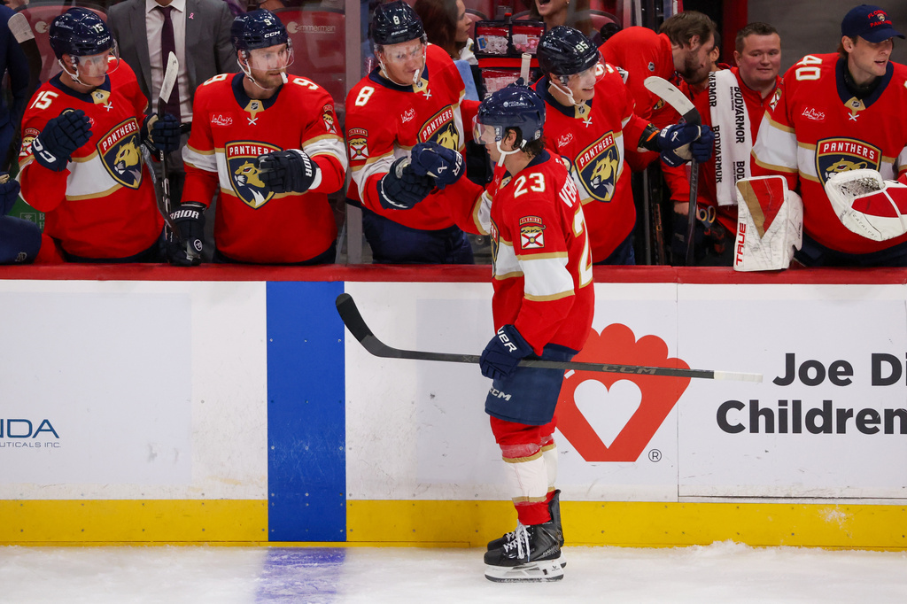 Florida Panthers center Carter Verhaeghe (23) celebrates with teammates after completing a hat trick during the second period of an NHL hockey game against the Seattle Kraken, Saturday, Oct. 17, 2026, in Sunrise, Fla. (AP Photo/David Santiago)
