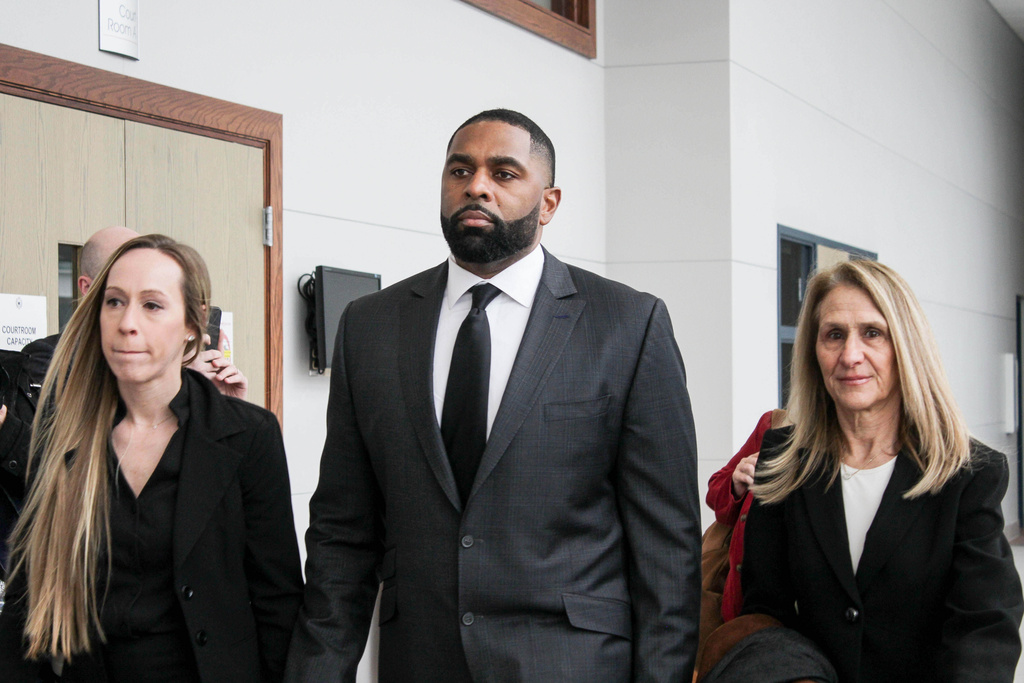 Former Michigan football coach Sherrone Moore arrives for a court hearing with his wife, Kelli Moore, left, and attorney Ellen Michaels, Friday, March 6 2026, at Washtenaw County 14A-1 District in Ann Arbor, Mich. (Jordyn Pair/Ann Arbor News via AP)