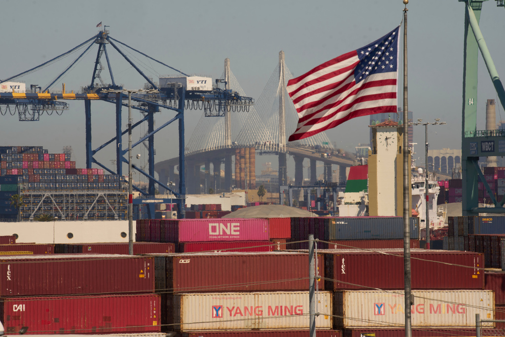 FILE - Containers with Yang Ming Marine Transport Corporation, a Taiwanese container shipping company, are stacked up at the Port of Los Angeles with the the Long Beach International Gateway Bridge seen in the background on Wednesday, April 9, 2025 in Los Angeles. (AP Photo/Damian Dovarganes, File)