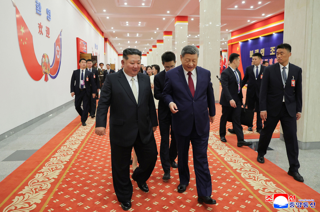 In this photo provided by the North Korean government, North Korean leader Kim Jong Un, left, and Chinese President Xi Jinping, right, walk together after a welcome performance in Pyongyang, Monday, June 8, 2026. Independent journalists were not given access to cover the event depicted in this image distributed by the North Korean government. The content of this image is as provided and cannot be independently verified. Korean language watermark on image as provided by source reads: "KCNA" which is the abbreviation for Korean Central News Agency. (Korean Central News Agency/Korea News Service via AP)
