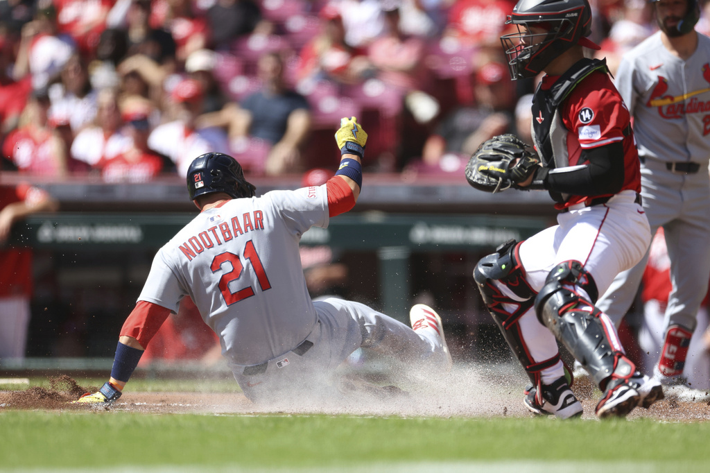 St. Louis Cardinals' Lars Nootbaar (21) slides home on a sacrifice fly by Nolan Gorman in the first inning against the Cincinnati Reds, Sunday, Aug. 31, 2025, in Cincinnati. (AP Photo/Abdoul Sow)
