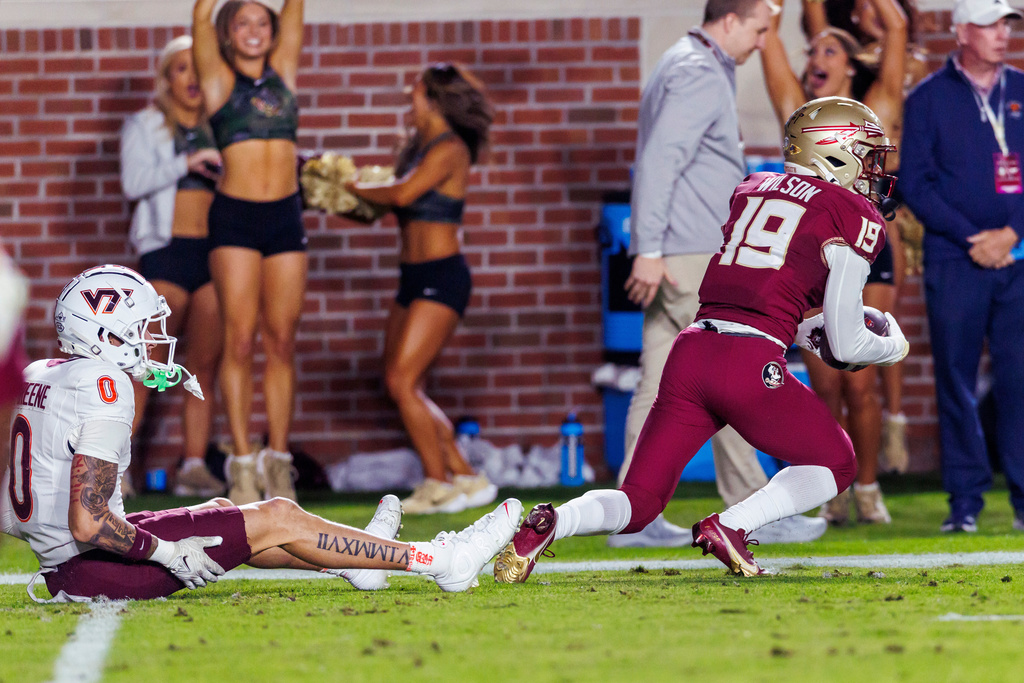 Florida State defensive back Jerry Wilson (19) comes up with an interception in front of Virginia Tech wide receiver Ayden Greene (0) during the first half of an NCAA college football game, Saturday, Nov. 15, 2025, in Tallahassee, Fla. (AP Photo/Colin Hackley)