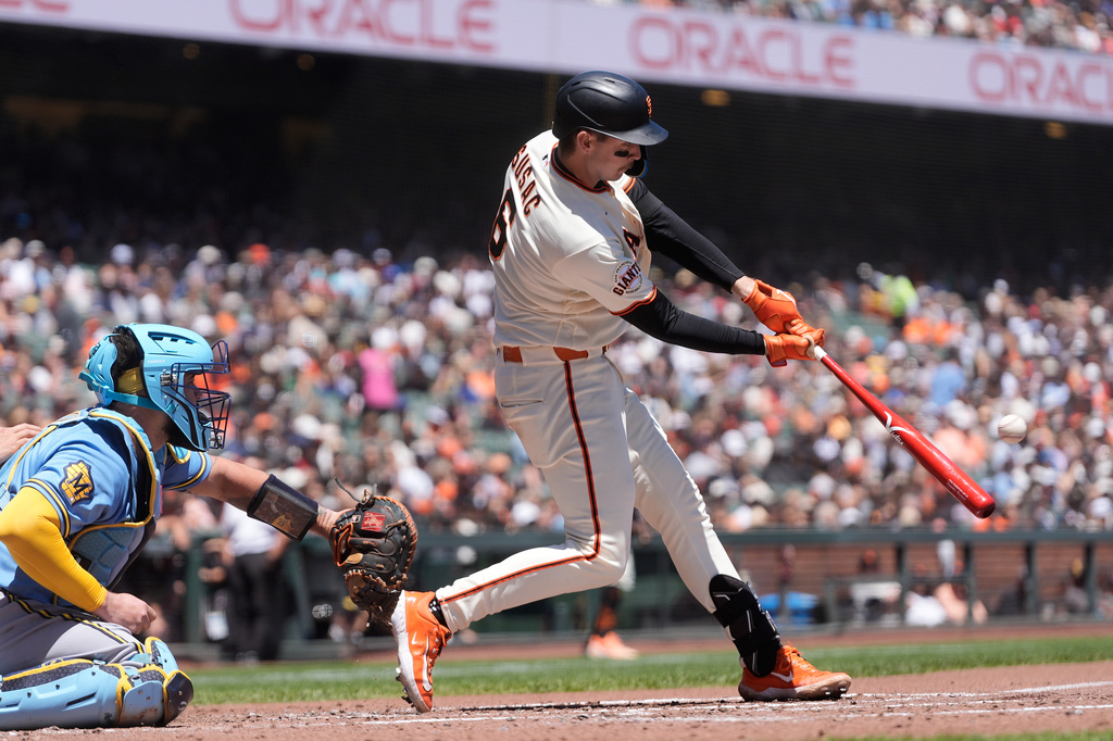 San Francisco Giants' Daniel Susac, right, hits a three-run home run next to Milwaukee Brewers catcher Gary Sánchez during the second inning of a baseball game, Wednesday, July 29, 2026, in San Francisco. (AP Photo/Jeff Chiu)