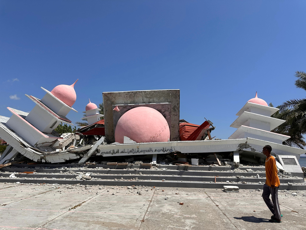 A man walks past a mosque collapsed during an earthquake in Lamba Leda, East Nusa Tenggara province, Indonesia, Tuesday, Aug. 18, 2026. (AP Photo/Firdia Lisnawati)