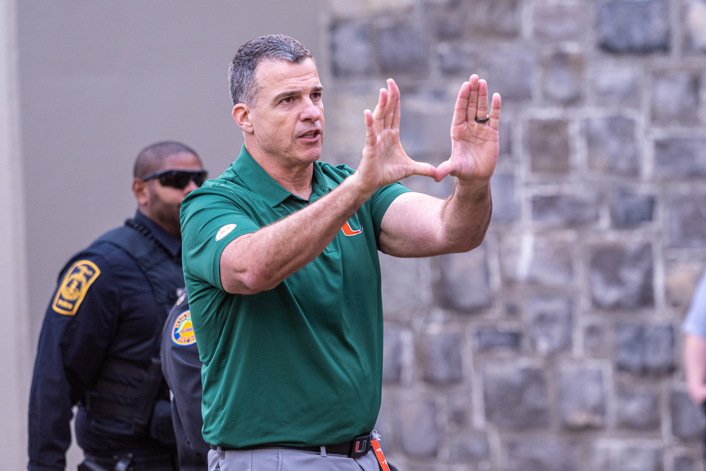Miami head coach Mario Cristobal gestures towards the fans after defeating Virginia Tech in an NCAA college football game, Saturday, Nov. 22, 2025, in Blacksburg, Va. (AP Photo/Robert Simmons)