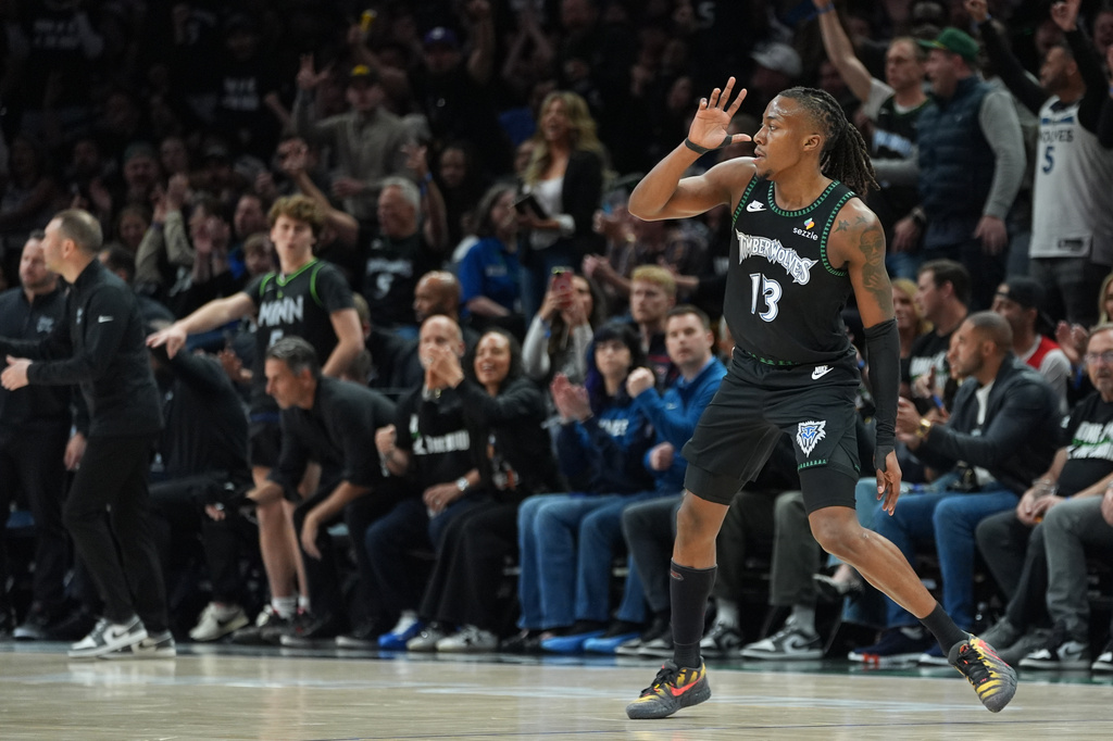 Minnesota Timberwolves guard Ayo Dosunmu (13) celebrates after making a 3-point basket during the first half of Game 4 of a first-round NBA basketball playoff series against the Denver Nuggets, Saturday, April 25, 2026, in Minneapolis. (AP Photo/Abbie Parr)