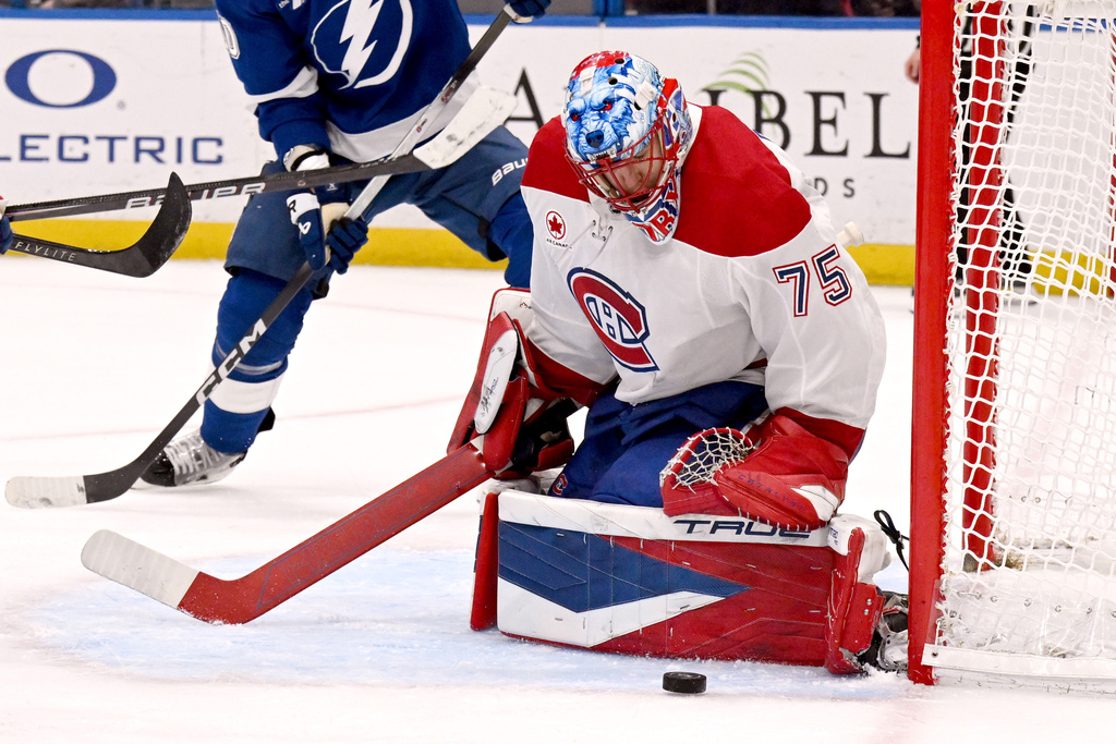 Montréal Canadiens goaltender Jakub Dobes makes a save during the second period of an NHL hockey game against the Tampa Bay Lightning, Tuesday, March 31, 2026, in Tampa, Fla. (AP Photo/Jason Behnken)