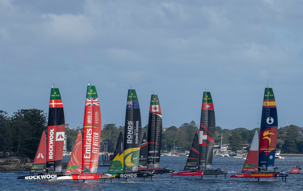 SailGP fleet led by ROCKWOOL Racing SailGP Team ahead of Emirates Great Britain SailGP Team and BONDS Flying Roos SailGP Team start the first race as they pass Shark Island on Race Day 1 of the KPMG Australia Sail Grand Prix in Sydney, Australia. Saturday, Feb. 28,2026. (Andrew Baker/SailGP via AP)