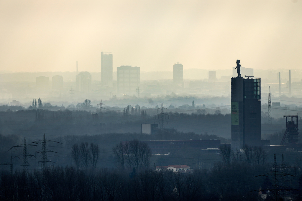 FILE - The city center of Essen is seen through the fog as German Federal Environment Agency warns about poor air quality in Germany due to fine dust pollution, Essen, Germany, Feb. 12, 2025. (AP Photo/Martin Meissner, File)