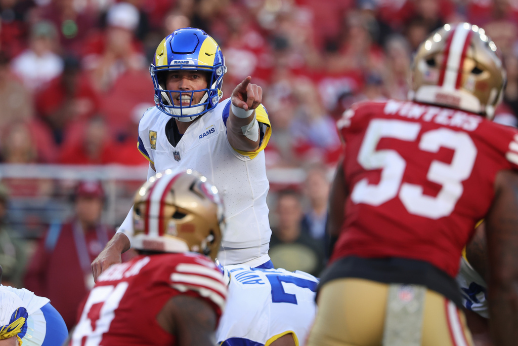 Los Angeles Rams quarterback Matthew Stafford, left, signals at the line of scrimmage during the second half of an NFL football game against the San Francisco 49ers in Santa Clara, Calif., Sunday, Nov. 9, 2025. (AP Photo/Jed Jacobsohn)
