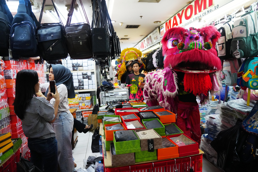 Lion dancers perform at a market in preparation for the Lunar New Year celebration in Jakarta, Indonesia, Thursday, Feb. 12, 2026.( AP Photo/Tatan Syuflana)