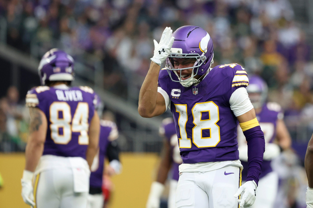 Minnesota Vikings wide receiver Justin Jefferson (18) reacts after catching a pass during the first half of an NFL football game against the Green Bay Packers, Sunday, Jan. 4, 2026, in Minneapolis. (AP Photo/Ellen Schmidt)
