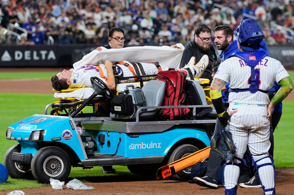 New York Mets first baseman Jared Young is brought off the field on a stretcher after colliding with pitcher Nolan McLean during the sixth inning of a baseball game against the Philadelphia Phillies, Thursday, Sept. 17, 2026, in New York. (AP Photo/Seth Wenig)