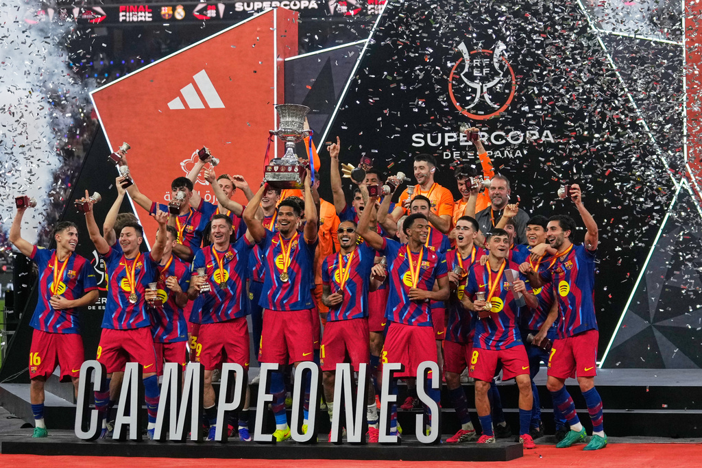 Barcelona players celebrate after winning the Spanish Super Cup final soccer match against Real Madrid at King Abdullah Sports City Stadium in Jeddah, Saudi Arabia, Sunday, Jan. 11, 2026. (AP Photo/Altaf Qadri)