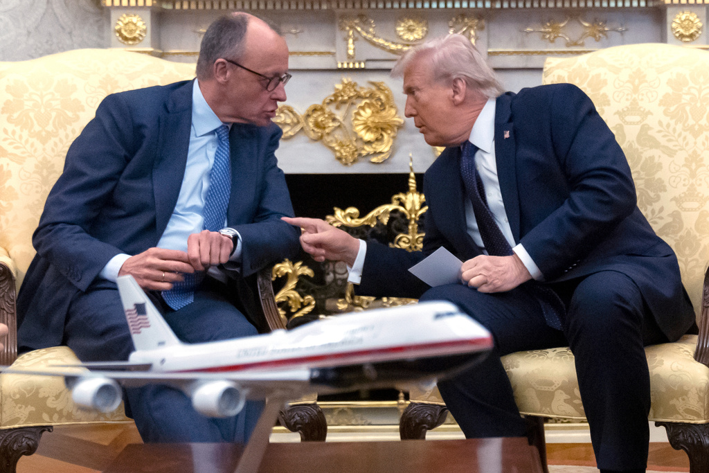 President Donald Trump, right, talks with German Chancellor Friedrich Merz during a meeting in the Oval Office at the White House, Tuesday, March 3, 2026, in Washington. (AP Photo/Mark Schiefelbein)