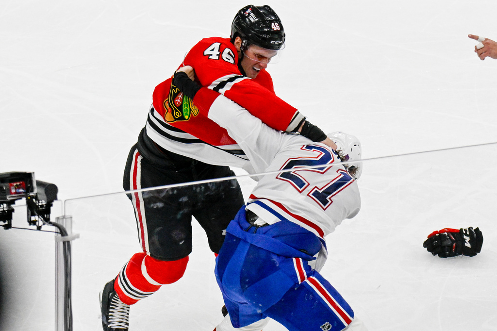 Chicago Blackhawks defenseman Louis Crevier (46) and Montreal Canadiens defenseman Kaiden Guhle (21) fight during the second period of an NHL hockey game Saturday, Oct. 11, 2025, in Chicago. (AP Photo/Matt Marton)
