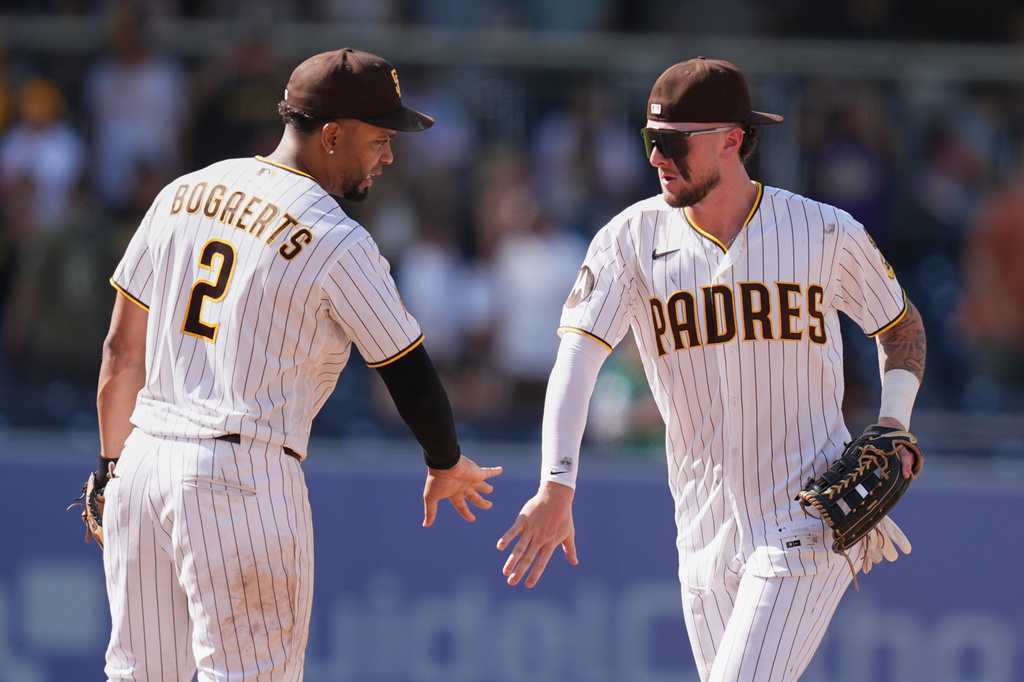San Diego Padres center fielder Jackson Merrill, right, celebrates with shortstop Xander Bogaerts after the Padres defeated the Pittsburgh Pirates 3-0 in a baseball game Wednesday, Aug. 26, 2026, in San Diego. (AP Photo/Gregory Bull)