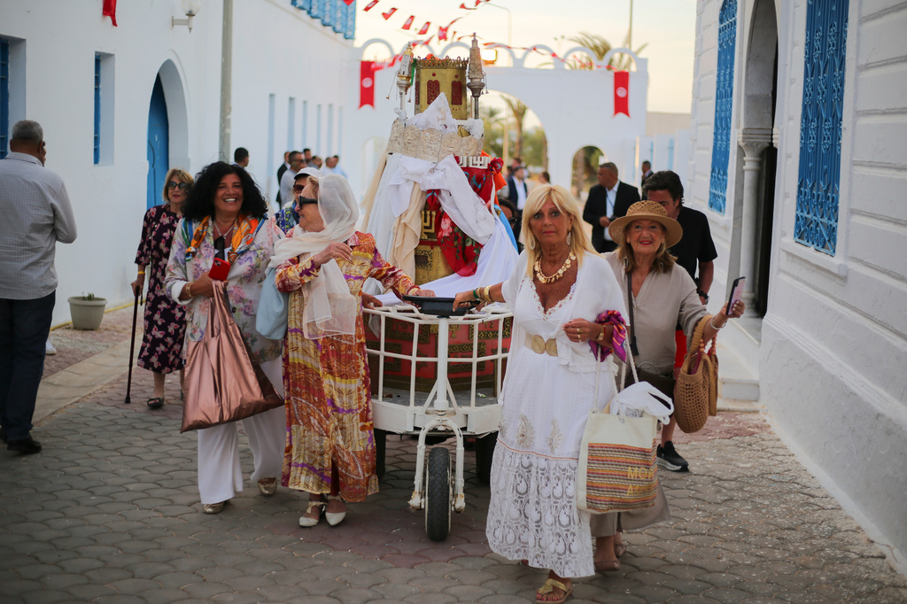 Jewish pilgrims take part in a procession as they attend an annual pilgrimage at the Ghriba synagogue in the resort of Djerba, Tunisia, on Monday, May 4, 2026. (AP Photo/Bassem Aouini)