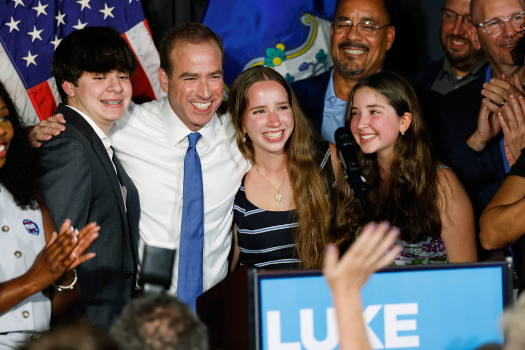 Luke Bronin, former Hartford mayor and Democratic candidate for Connecticut's 1st congressional district, stands on stage with his children during an election night watch party Tuesday, Aug. 11, 2026, in Hartford, Conn. (AP Photo/Rusty Jones)