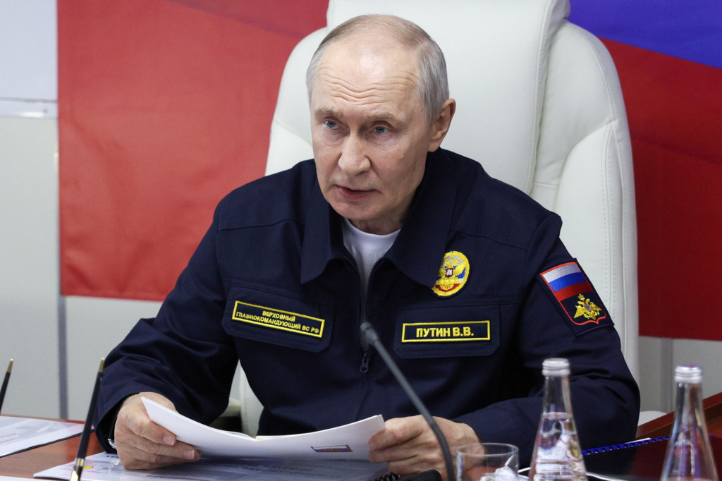 Russian President Vladimir Putin visits the Varyag missile cruiser of the Pacific Fleet to watch a military exercise near Yuzhno-Sakhalinsk, on Sakhalin Island, Russia, Wednesday, Aug. 12, 2026. (Gavriil Grigorov, Sputnik, Kremlin Pool Photo via AP)