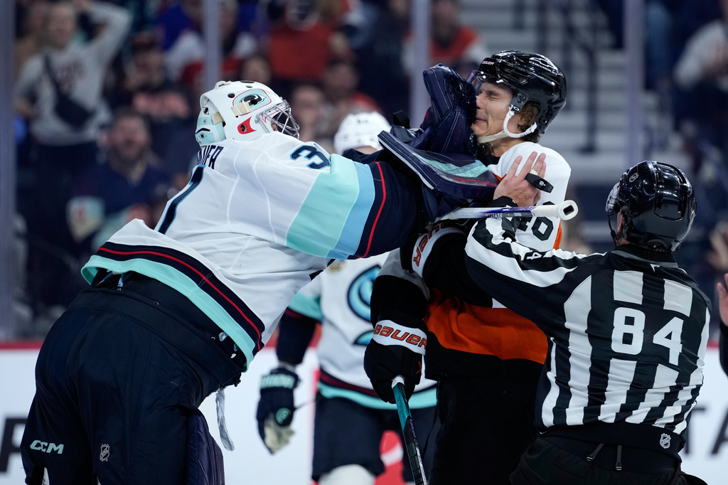 Seattle Kraken's Philipp Grubauer, left, and Philadelphia Flyers' Trevor Zegras scuffle during the second period of an NHL hockey game Tuesday, Oct. 13, 2026, in Philadelphia. (AP Photo/Matt Slocum)
